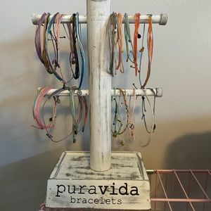 23 Pura Vida bracelets plus the stand
